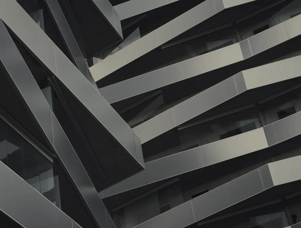 Abstract close-up of angular architectural forms in graphite tones